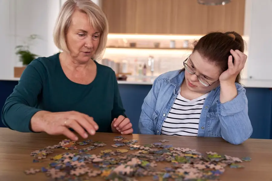 Focus Down Syndrome Woman Her Mother Assembling Puzzles Home 1112411 8281