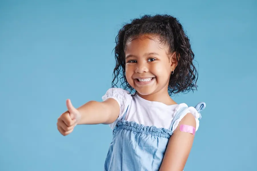Thumbs Up Plaster Portrait Child Studio Injection Vaccine Medical Booster Shot Happy Healthcare Girl Kid From Mexico With Bandage Arm Immunization By Blue Background 590464 503275