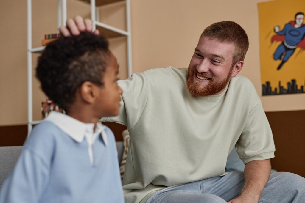 Smiling Father Supporting Black Boy While Sitting Couch Indoors 236854 64288